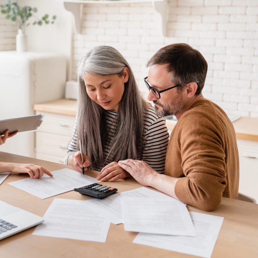 Couple signing insurance documents