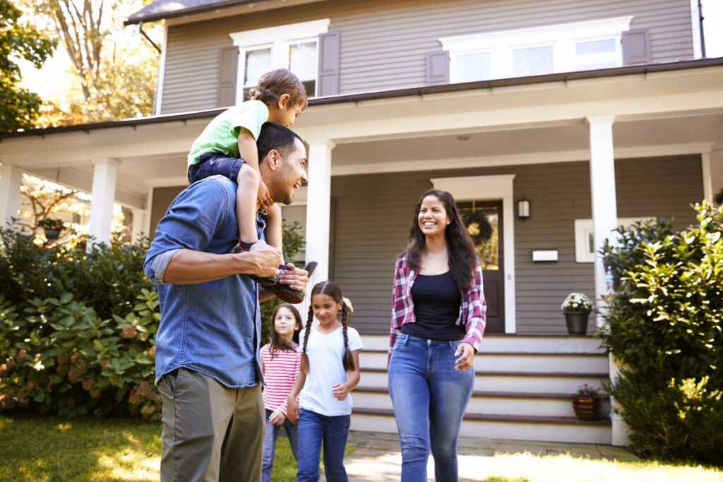 family in front of their home
